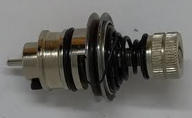 A sewing machine tension unit that has been removed from the machine. There is a dial that can be turned to adjust a spring, which moves the tension discs closer together or further apart.