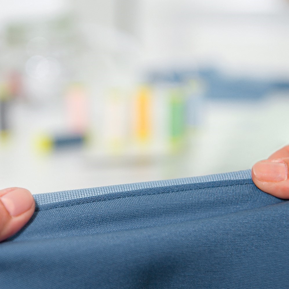 A piece of blue fabric that has been sewn with Maraflex being stretched